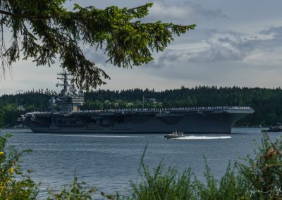 A US Navy patrol boat circles the ship - USS Nimitz departs for deployment 2017